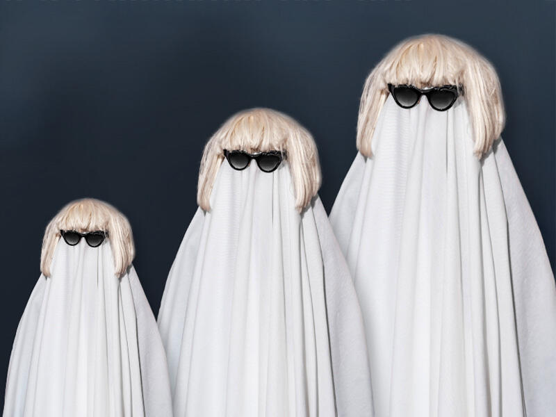 Trio di persone travestiti da fantasmi con lenzuolo bianco, occhiali da sole e parrucche bionde